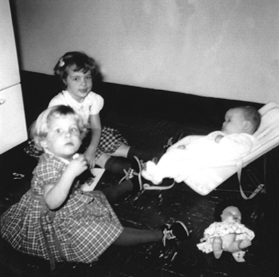 Heidi Lyn, Marilu Fances (front left) and Sally Anne (back left) in the Johnsons' UM married student housing kitchen, 1961.